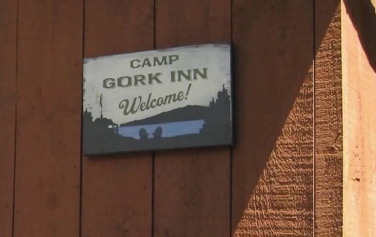 Eric&rsquo;s hand-painted Camp Gork Inn welcome sign by the door