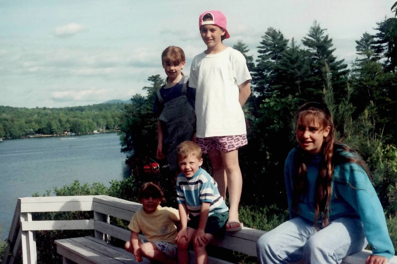 Kids lined up on the dock rail