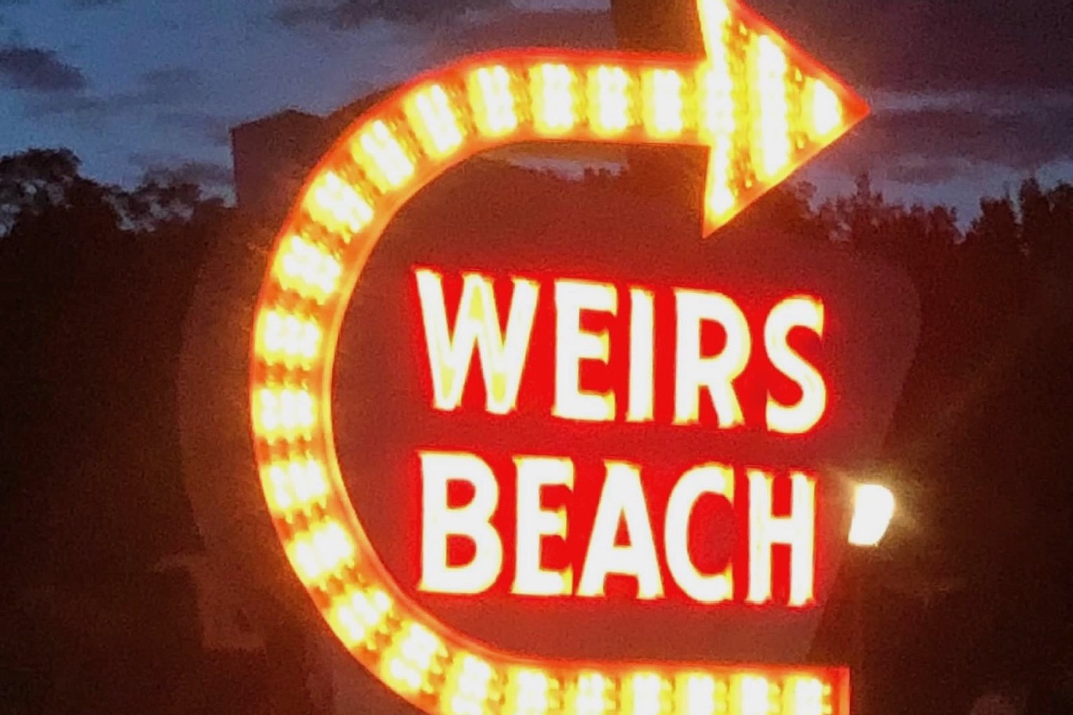 The Weirs Beach neon sign at night