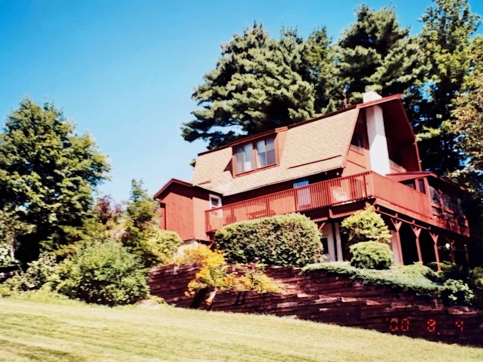 The Inn in its red years, above the lawn